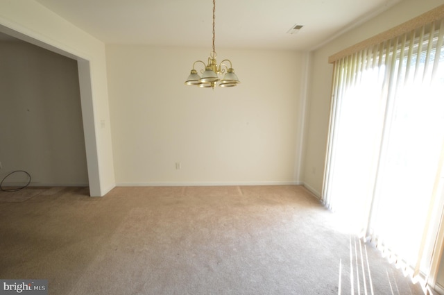 unfurnished room with light colored carpet and a chandelier