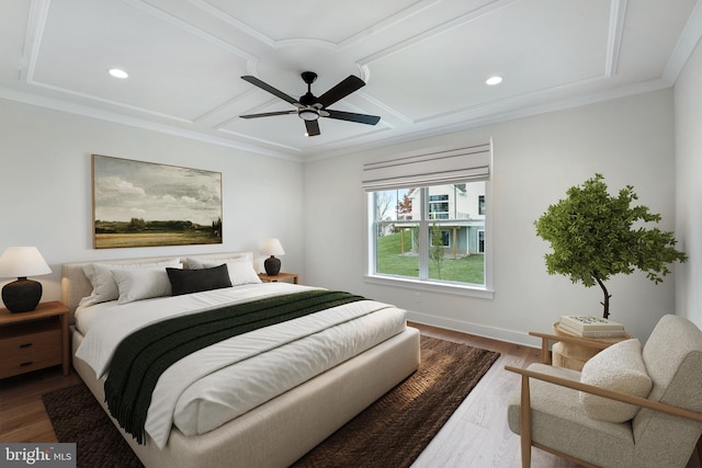 bedroom with ornamental molding, ceiling fan, coffered ceiling, and hardwood / wood-style floors