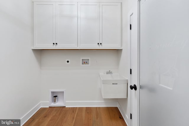 laundry room featuring washer hookup, light hardwood / wood-style flooring, cabinets, and hookup for an electric dryer