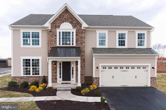 view of front facade featuring stone siding, driveway, a garage, and roof with shingles