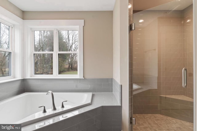 bathroom featuring separate shower and tub