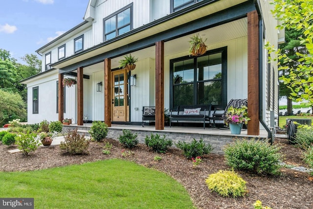 doorway to property featuring covered porch
