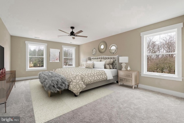 bedroom with carpet flooring, multiple windows, and ceiling fan