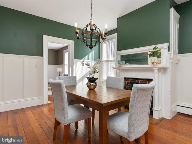 dining space with a notable chandelier and wood-type flooring