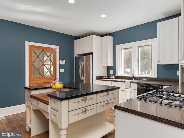 kitchen featuring dishwasher, white cabinets, sink, dark hardwood / wood-style floors, and stainless steel refrigerator