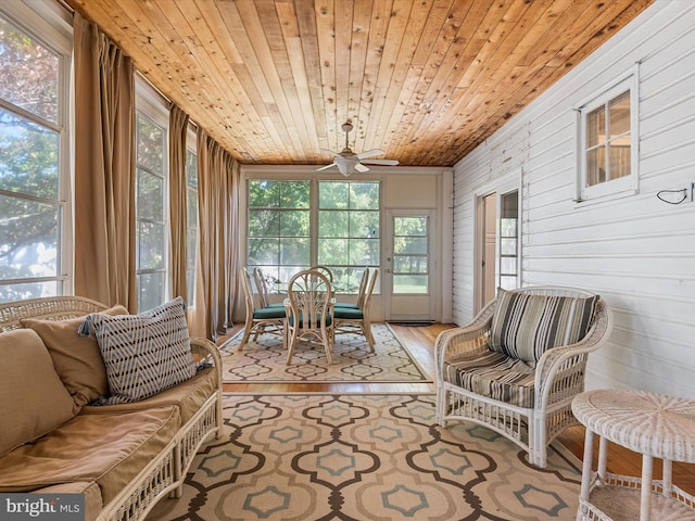 sunroom / solarium with ceiling fan and wooden ceiling