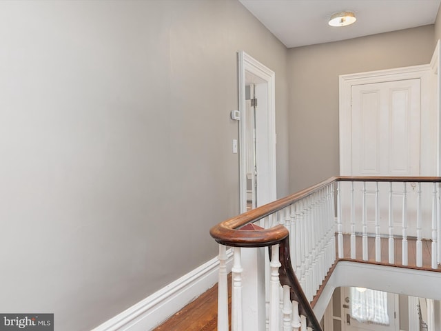 stairs with hardwood / wood-style floors