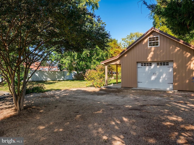 view of side of property with a garage and an outbuilding