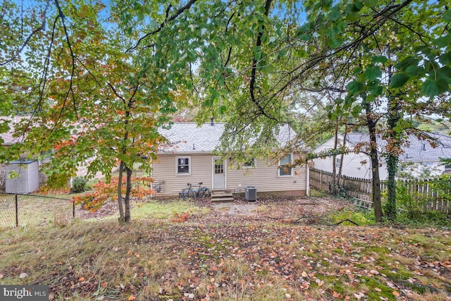 rear view of house featuring cooling unit