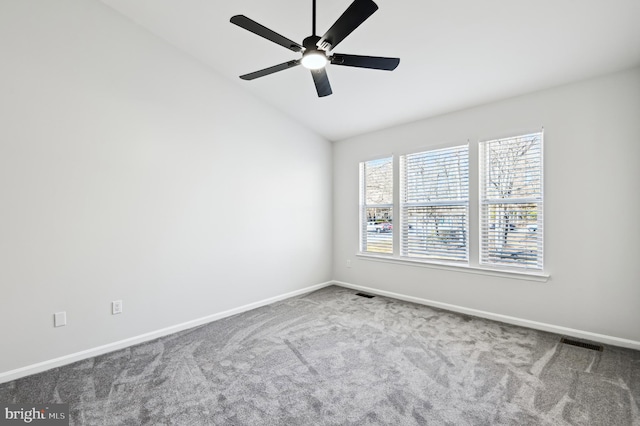 unfurnished room featuring vaulted ceiling, carpet, visible vents, and baseboards