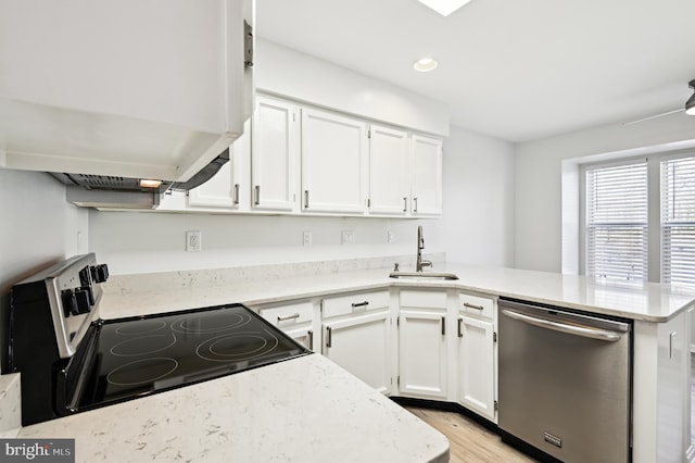 kitchen featuring electric range, a sink, stainless steel dishwasher, a peninsula, and exhaust hood