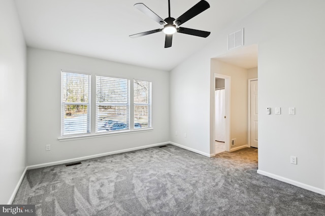 unfurnished room featuring lofted ceiling, baseboards, visible vents, and carpet floors