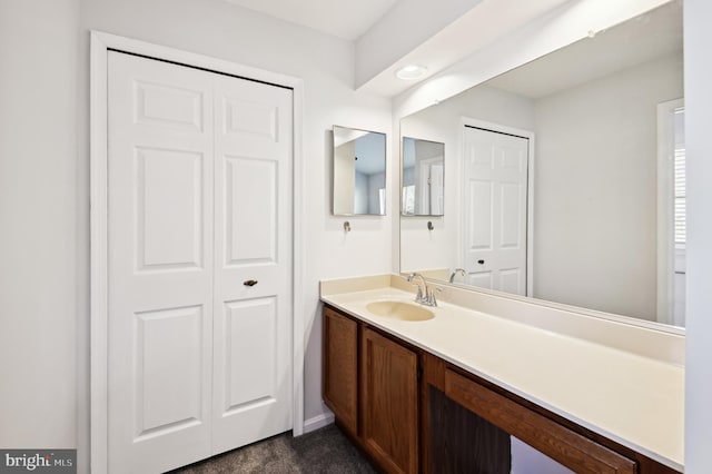 bathroom featuring a closet and vanity