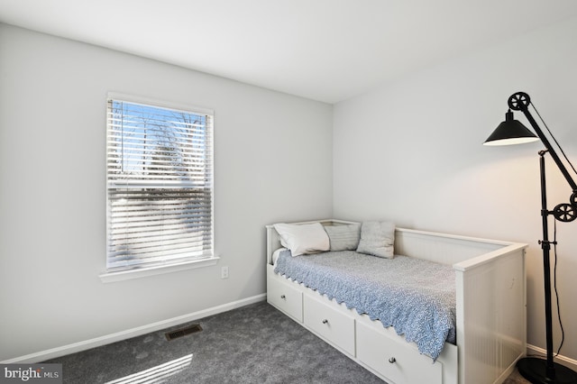 bedroom featuring visible vents, baseboards, and dark colored carpet