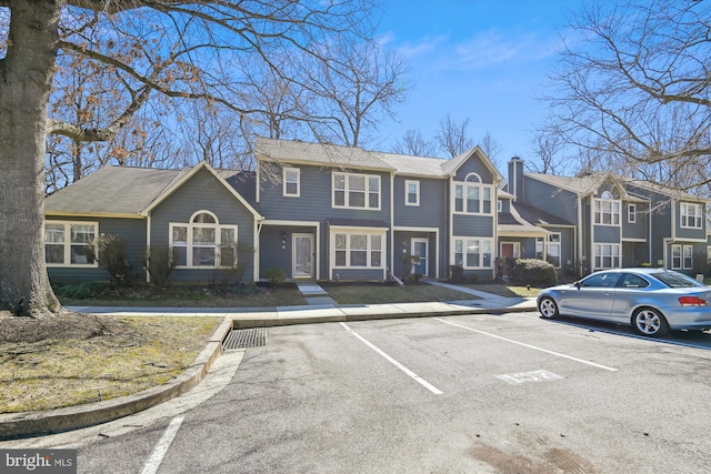 view of front facade featuring uncovered parking and a residential view