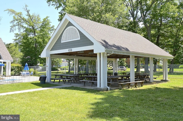 view of community featuring a gazebo, a yard, a pool, and fence