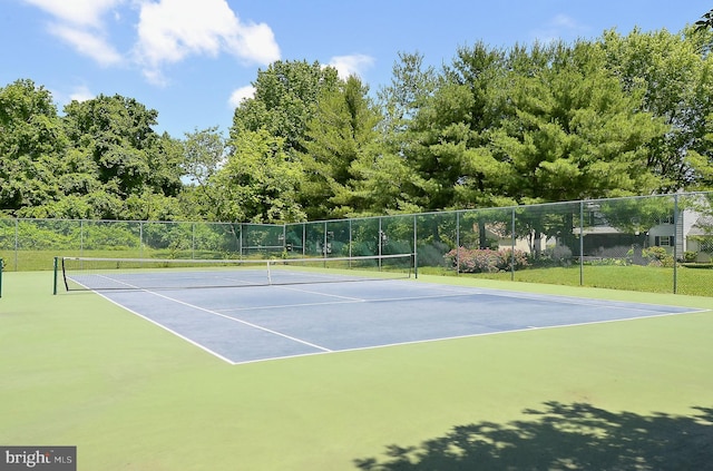 view of sport court featuring fence