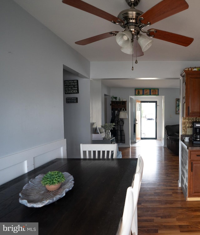 dining space with dark wood finished floors and a ceiling fan