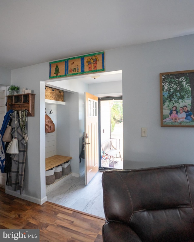 interior space featuring baseboards and wood finished floors