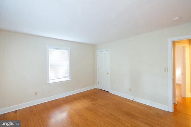 unfurnished room featuring hardwood / wood-style flooring