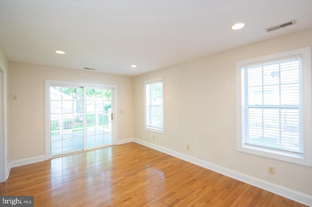 unfurnished room with light hardwood / wood-style flooring and a wealth of natural light