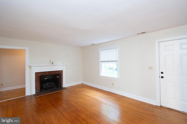 unfurnished living room featuring a fireplace and hardwood / wood-style floors