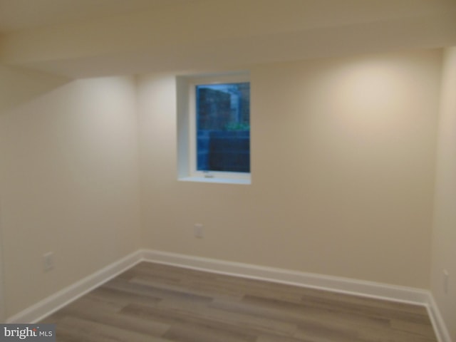 empty room with hardwood / wood-style flooring