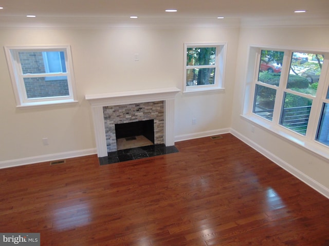 unfurnished living room with ornamental molding, lofted ceiling, dark wood-type flooring, and a fireplace