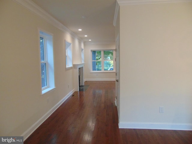 hall featuring ornamental molding and dark hardwood / wood-style flooring