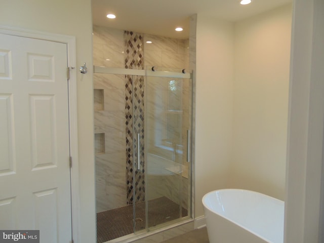 bathroom featuring independent shower and bath