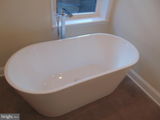 bathroom featuring a tub and tile patterned floors