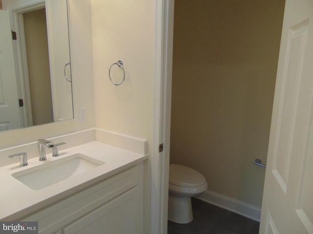 bathroom featuring vanity, toilet, and tile patterned floors