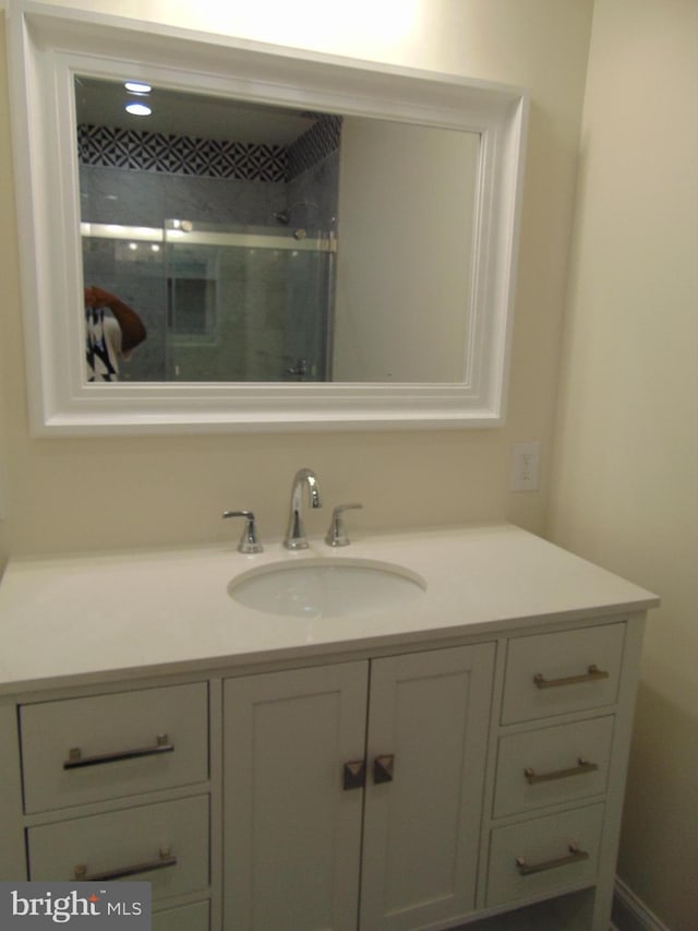 bathroom with vanity and a shower with shower door