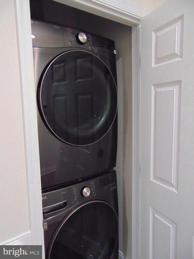 laundry area featuring stacked washer / dryer