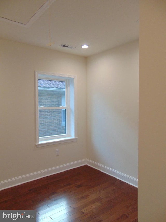 unfurnished room with dark hardwood / wood-style flooring