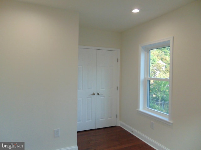 spare room featuring dark wood-type flooring