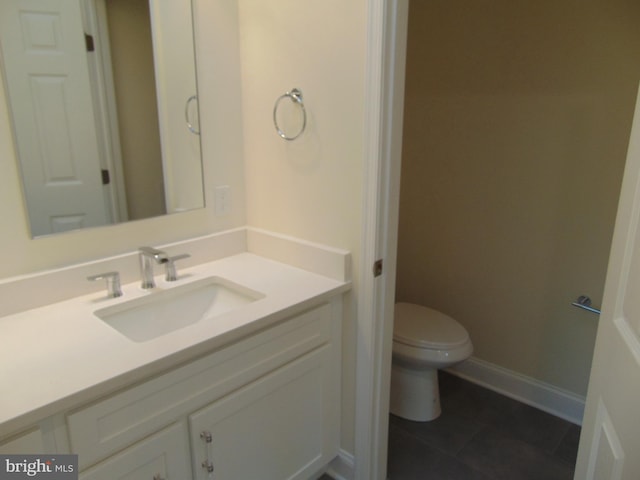 bathroom with tile patterned flooring, vanity, and toilet