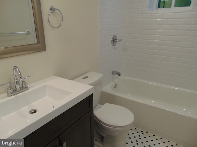 full bathroom featuring tiled shower / bath, vanity, toilet, and tile patterned floors