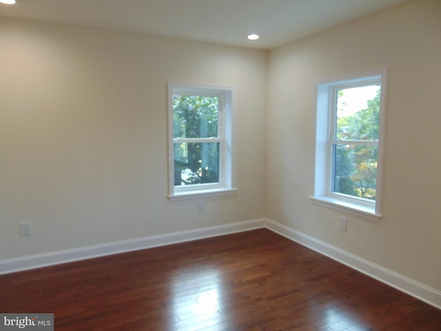 empty room featuring dark hardwood / wood-style flooring