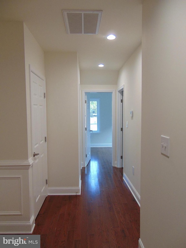 corridor featuring dark wood-type flooring