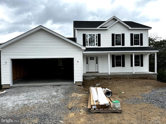 view of front property with a porch and a garage