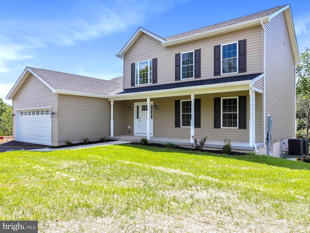 view of front of house featuring a garage, cooling unit, a front lawn, and covered porch