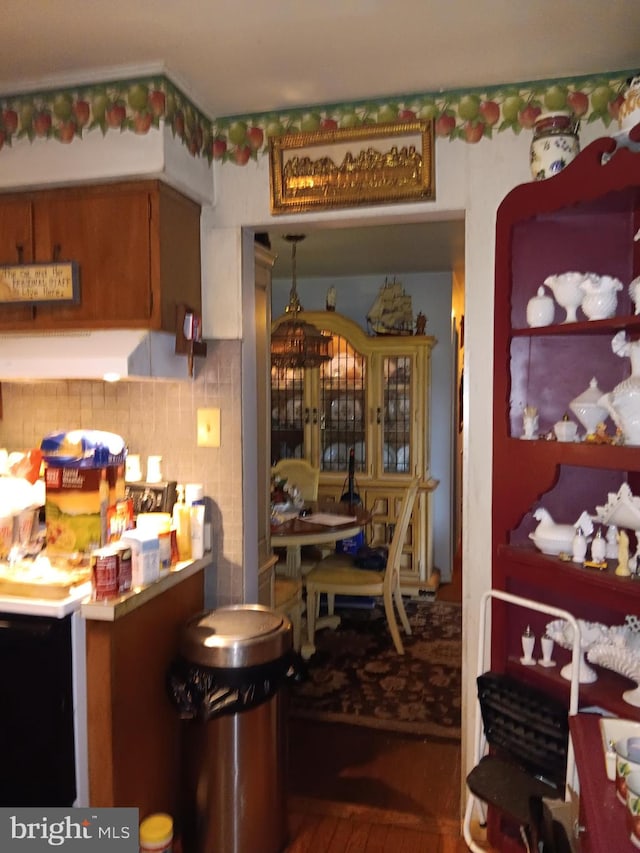 kitchen featuring backsplash and hardwood / wood-style flooring