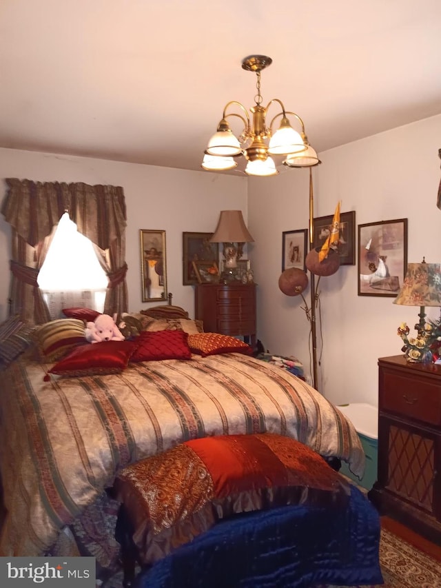 bedroom featuring an inviting chandelier