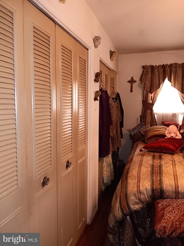 bedroom with a closet and dark hardwood / wood-style flooring