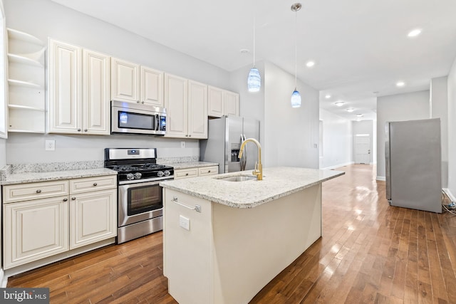 kitchen featuring pendant lighting, a kitchen island with sink, appliances with stainless steel finishes, and dark wood-type flooring