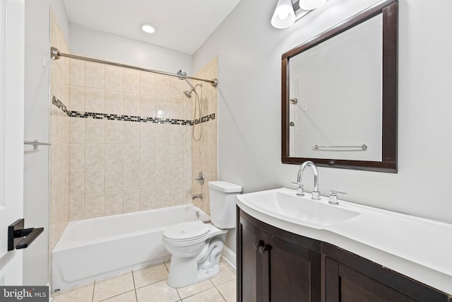 full bathroom featuring tile patterned floors, tiled shower / bath combo, vanity, and toilet