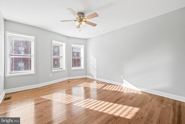 spare room featuring ceiling fan, plenty of natural light, and light hardwood / wood-style floors