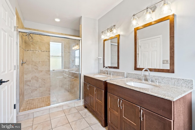 bathroom featuring vanity, an enclosed shower, and tile patterned floors