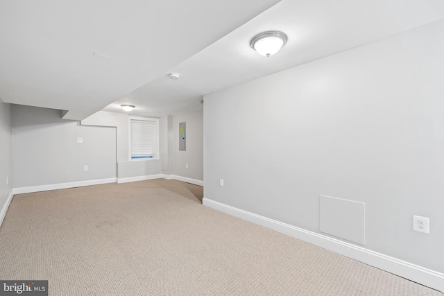 basement with electric panel and light colored carpet